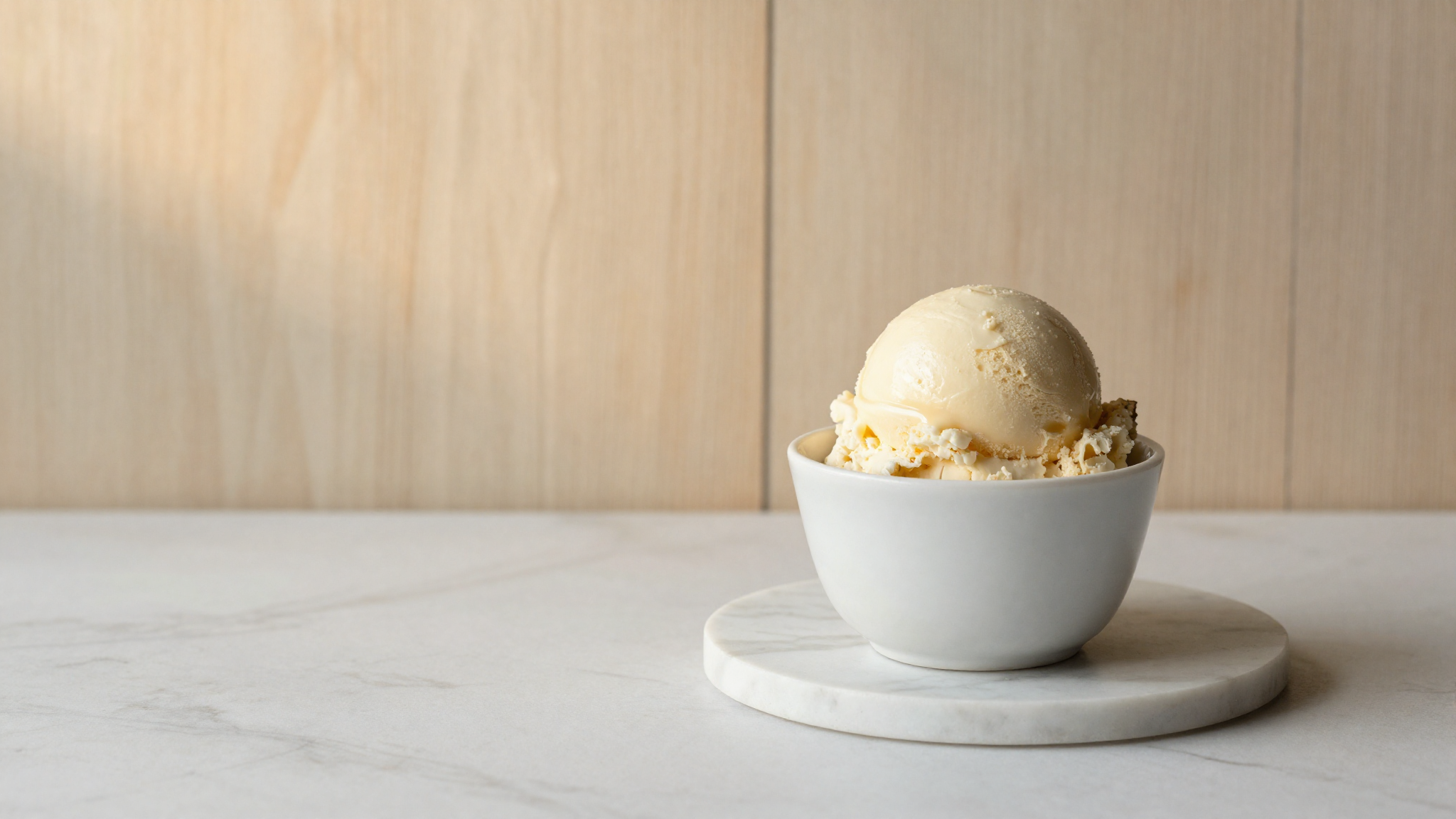 A soft scoop of agave-sweetened gelato in a white ceramic cup