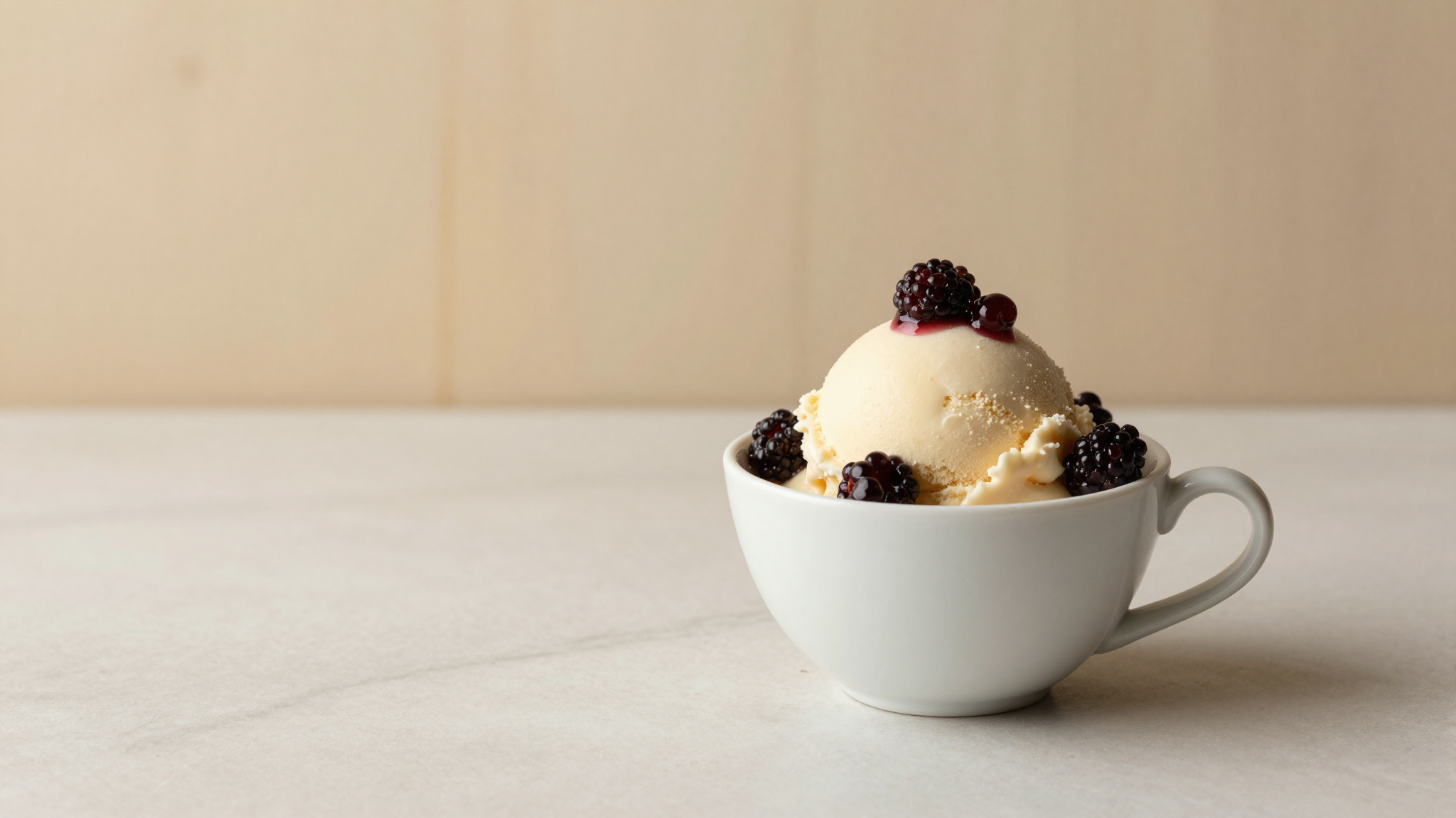 Amarena cherry gelato in a white ceramic cup topped with dark cherries in syrup