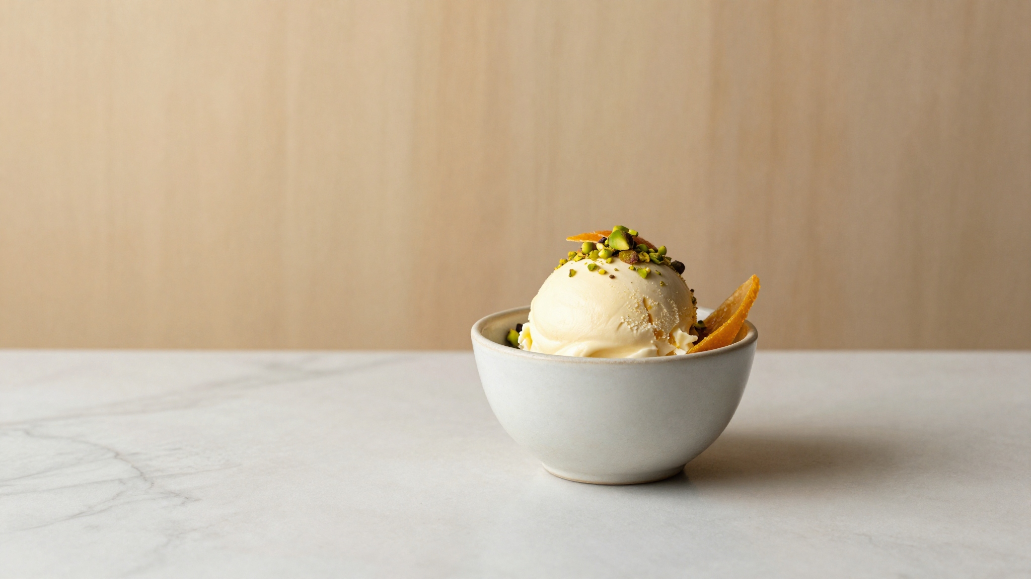 Cover photo of a finished serving of cassata siciliana gelato in a refined ceramic cup garnished simply with candied citrus and chopped pistachios