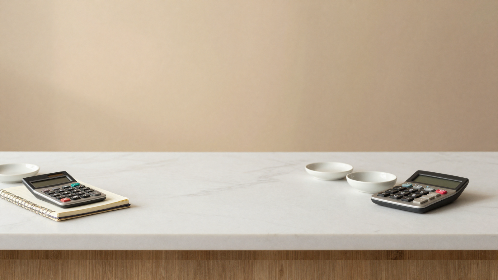 Notebook and calculator on a marble counter for tracking gelateria energy costs