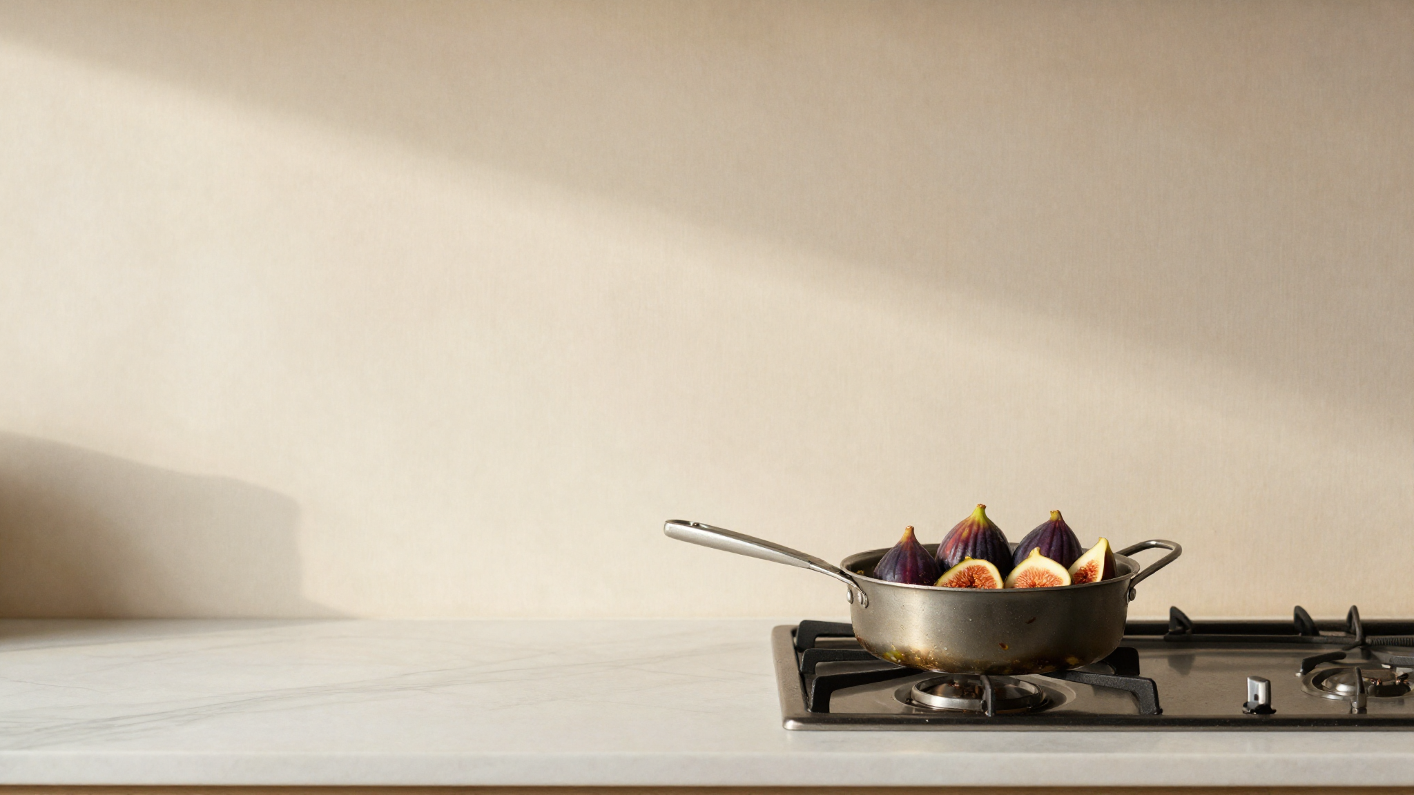 Fresh figs being simmered into a purée in a small saucepan
