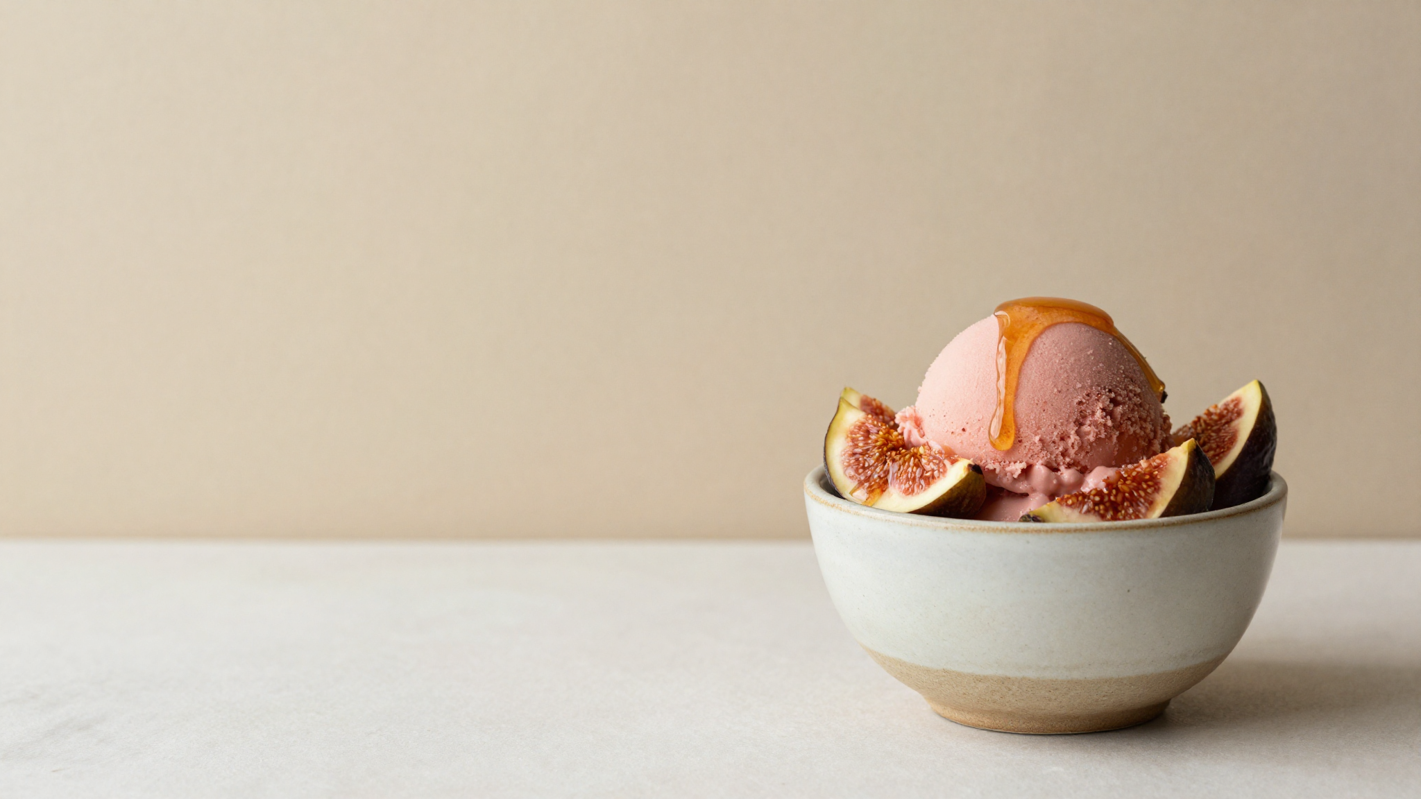 A scoop of fig and honey gelato served with a drizzle of honey