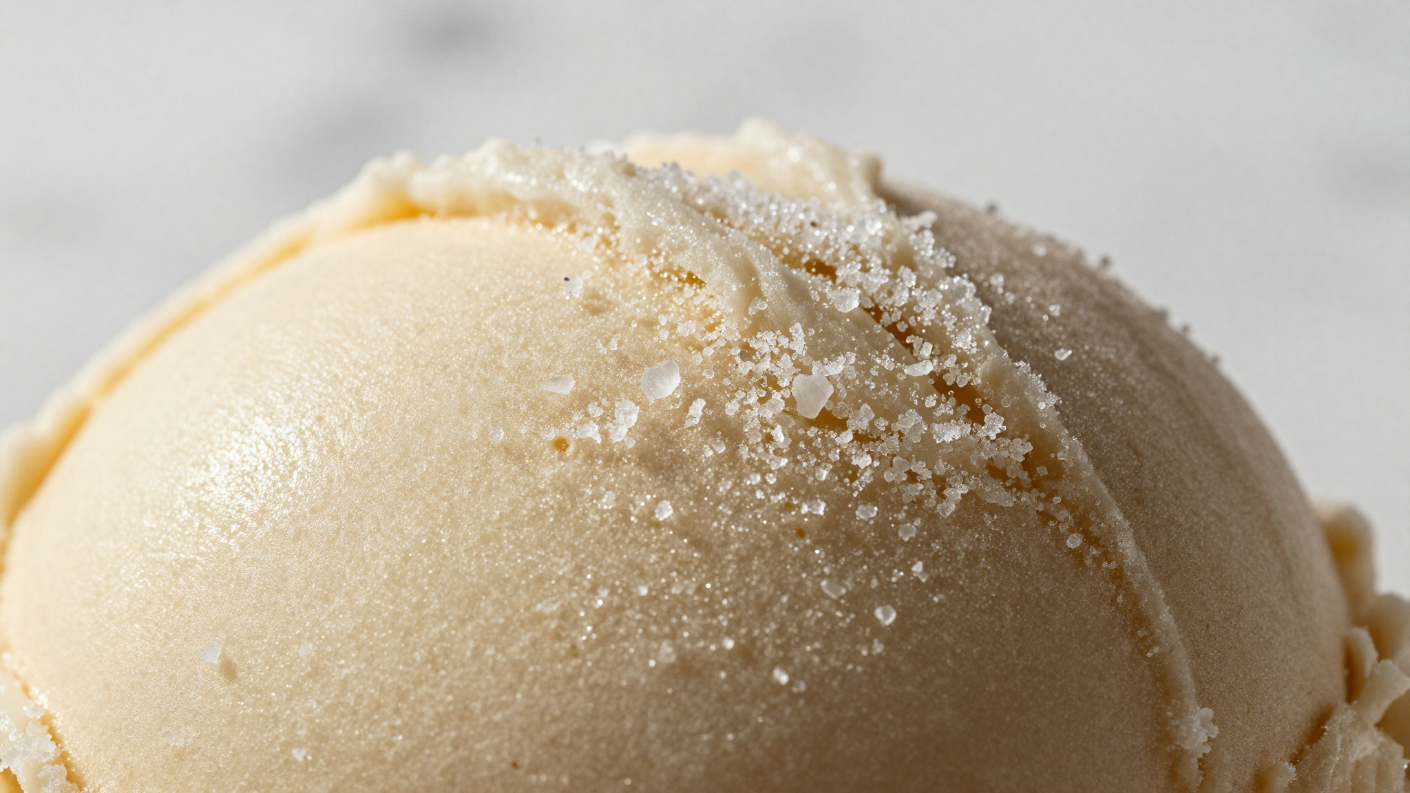 Macro close-up of ice crystals forming on the surface of dense italian gelato