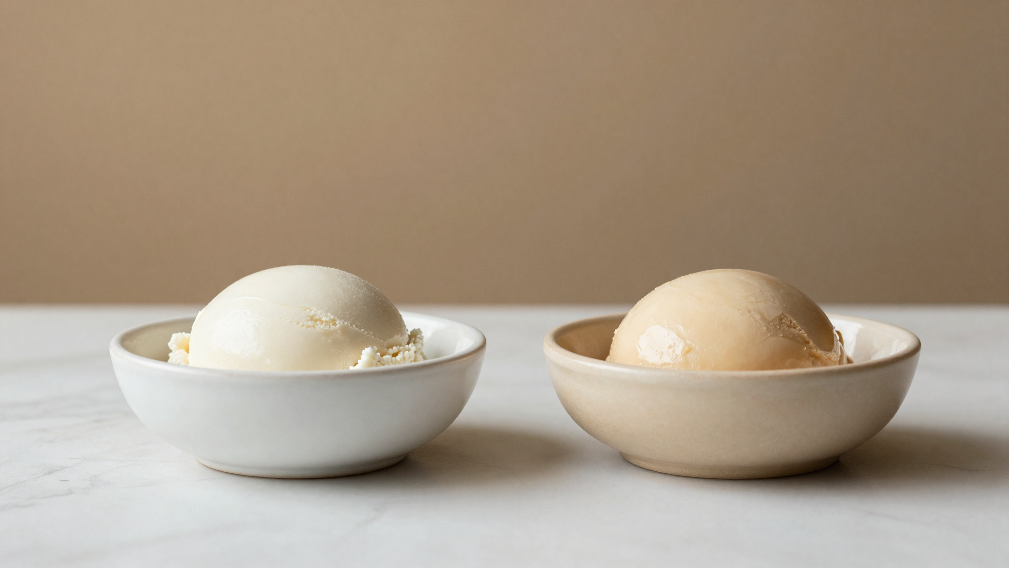 Two gelato bases side by side, one bright white and one tinted beige from over-pasteurization