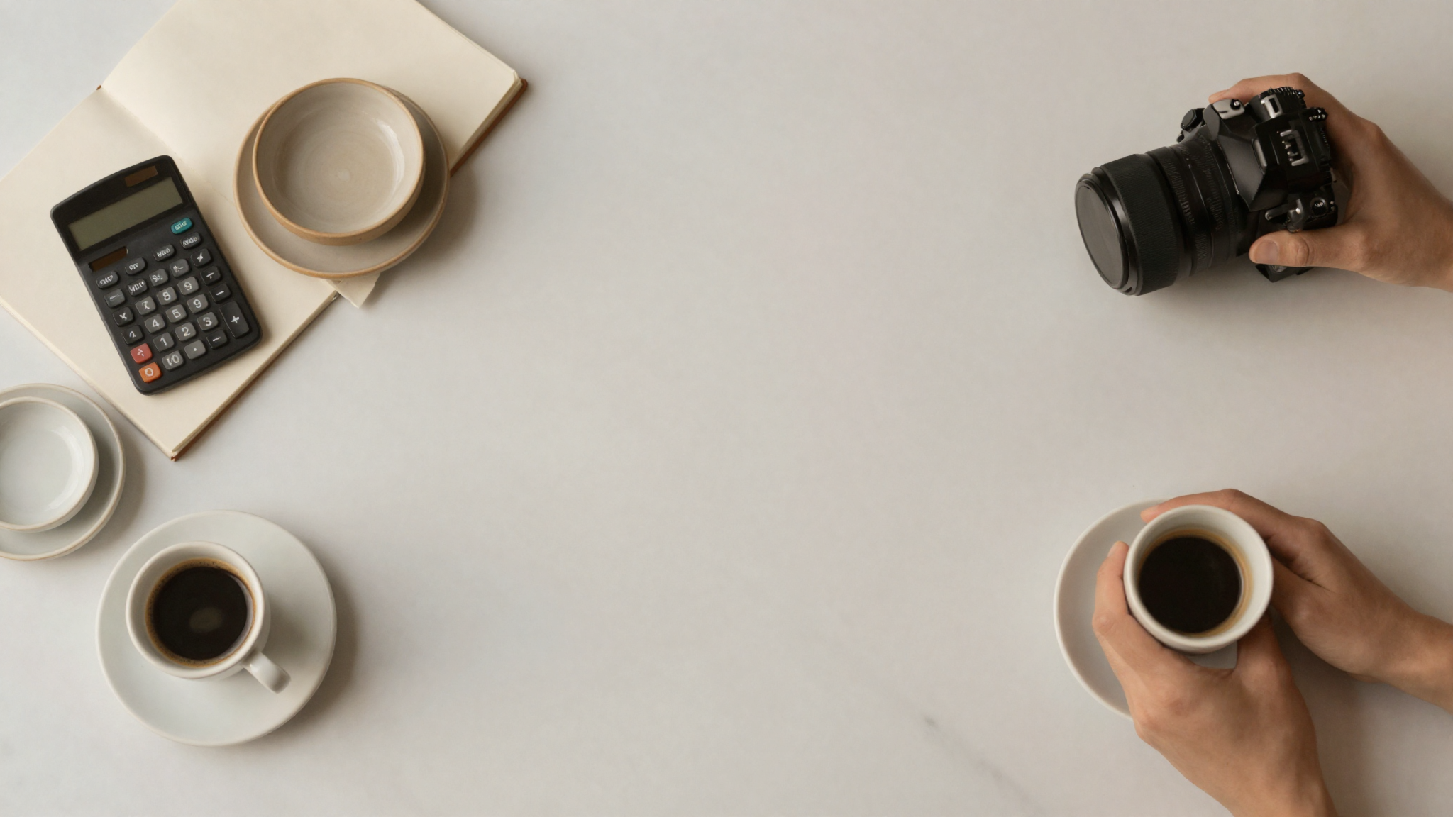 Marble counter flat lay with notebook, calculator and espresso cup