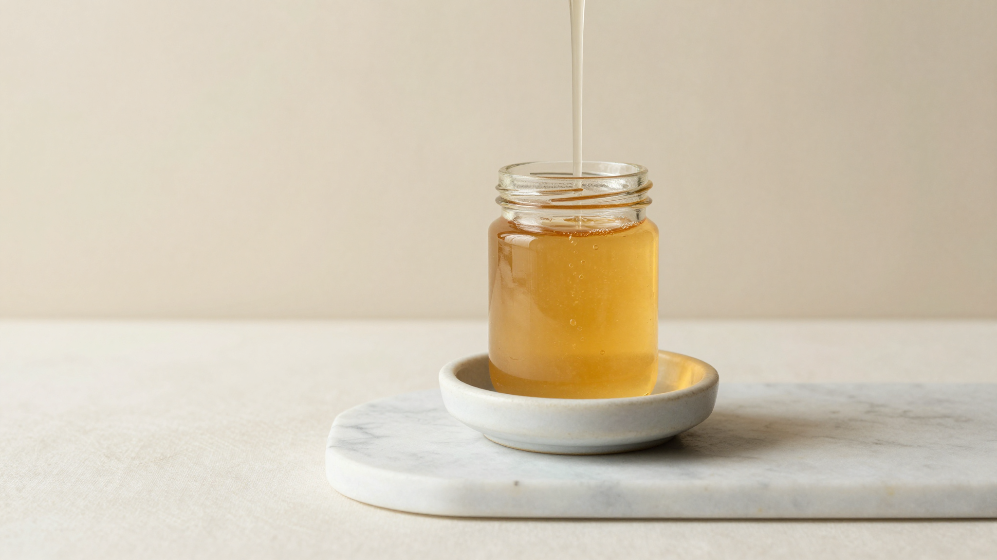 Golden inverted sugar syrup in a jar — hydrolyzed sucrose used in Italian gelato