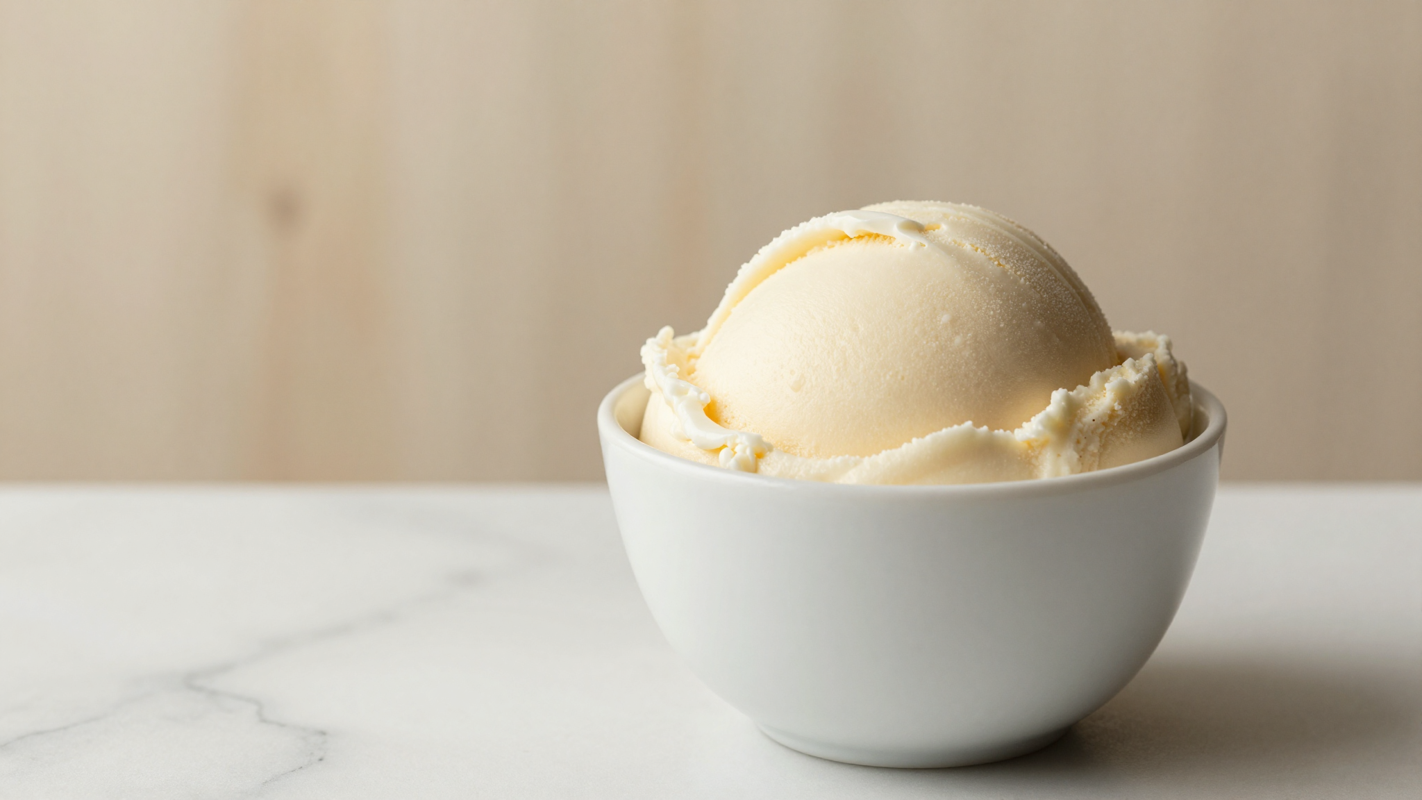 A close-up of finished no-added-sugar gelato in a small ceramic cup, smooth and creamy