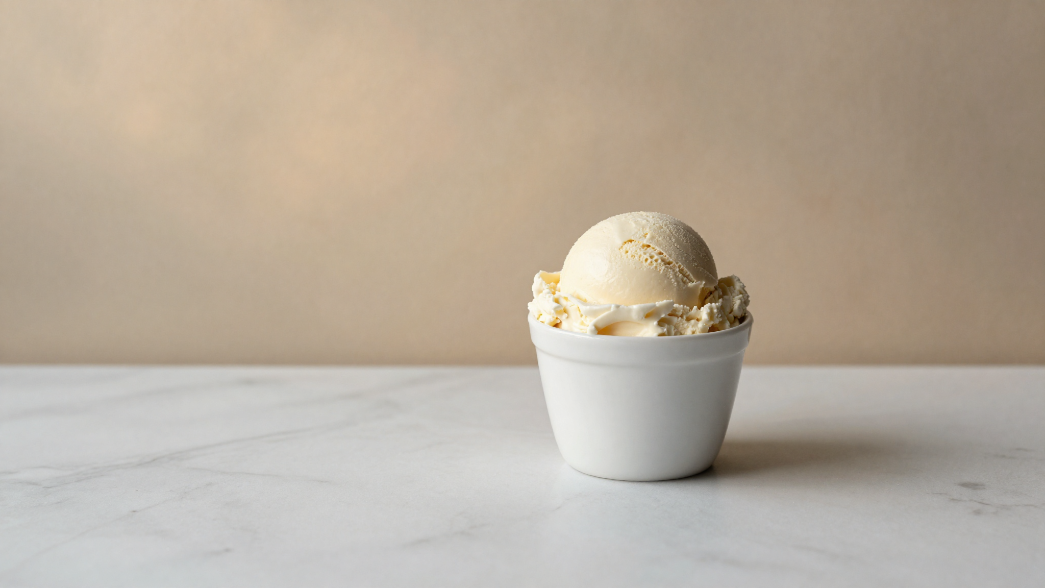 Finished scoop of sheep milk gelato in a white ceramic cup