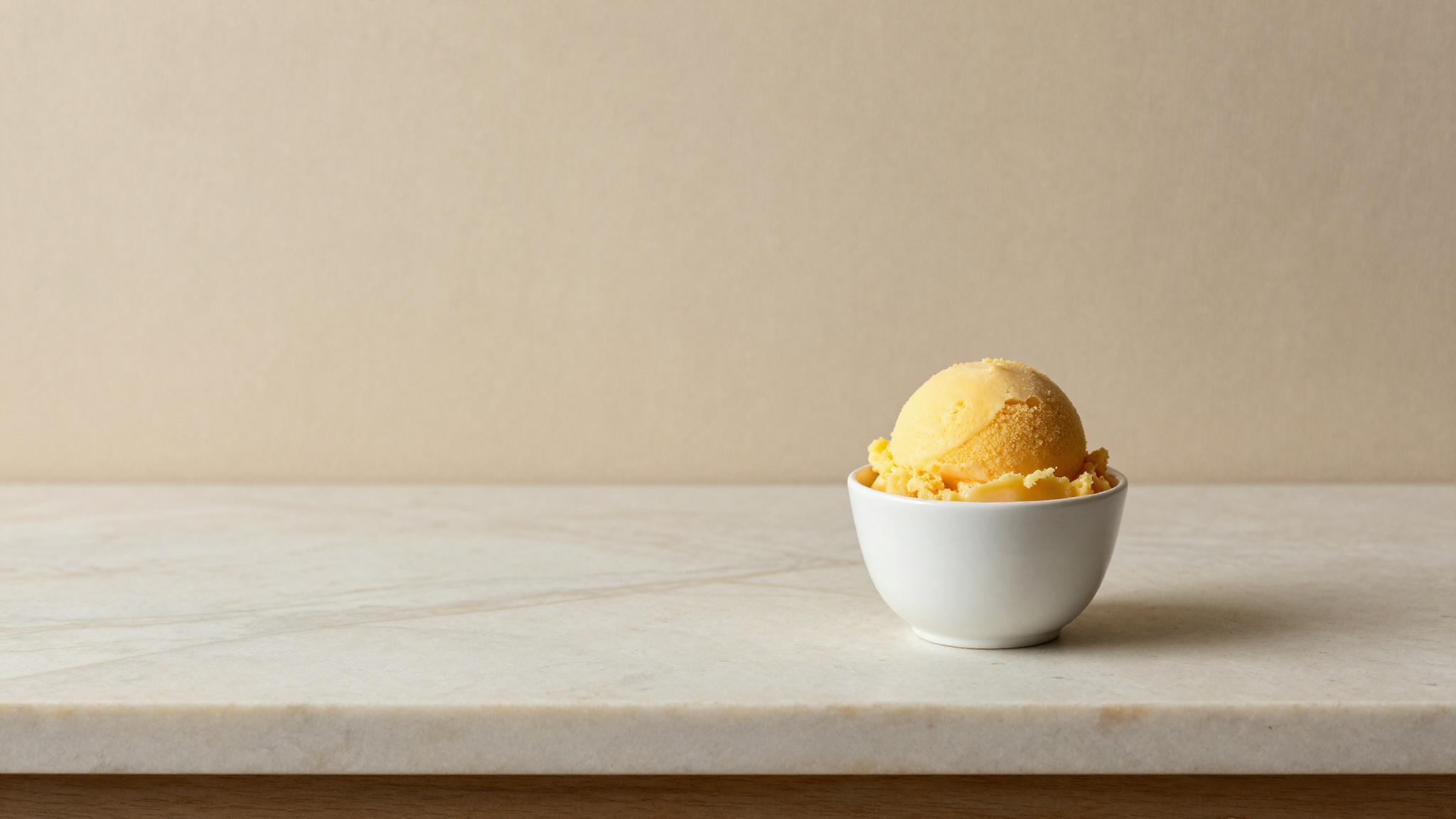 Hero photo of a freshly drawn sorbetto with subtle texture variation evoking phase separation defect on aged marble