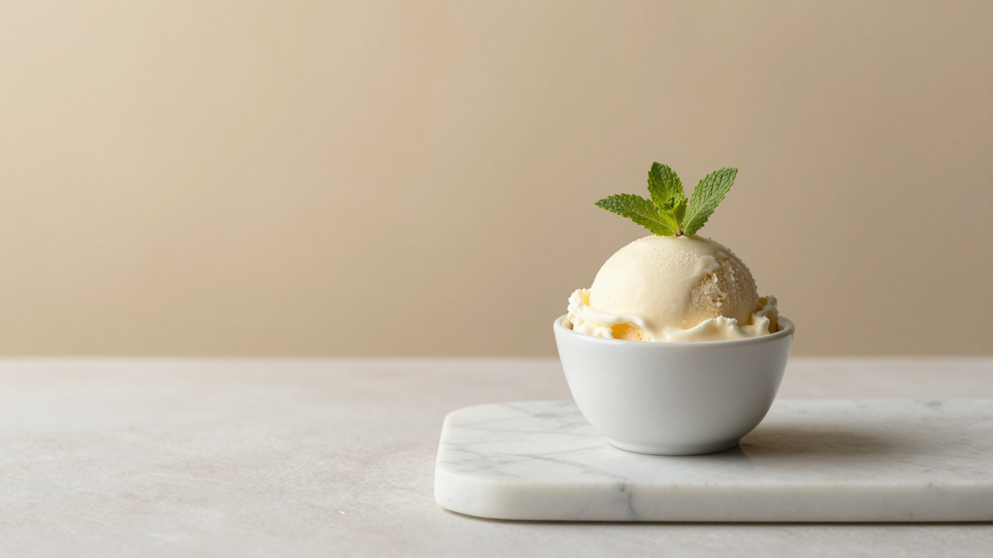 A scoop of tangy white buttermilk gelato in a ceramic cup