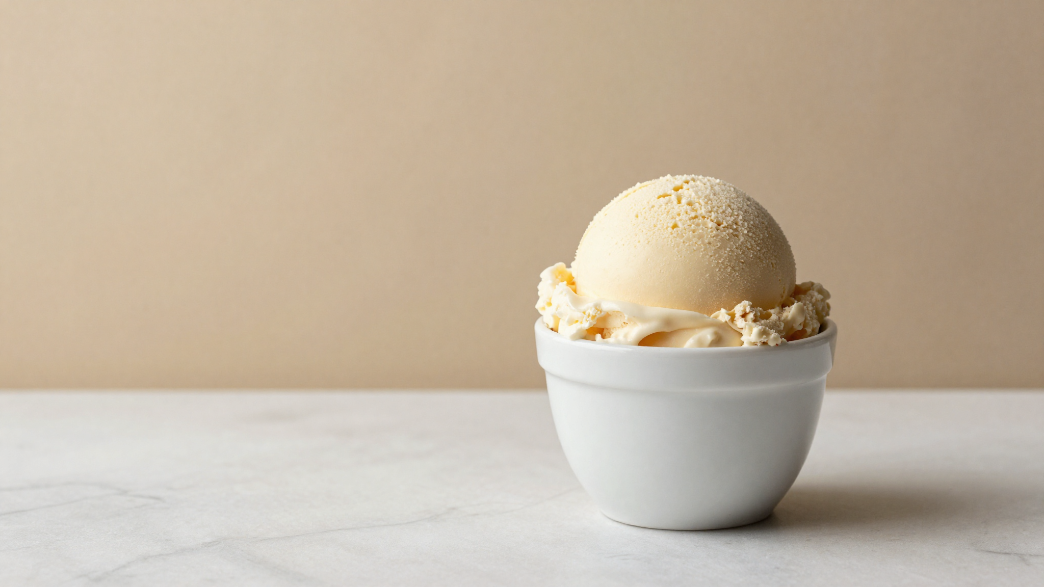 Scoop of italian gelato in white ceramic cup — aerated creamy texture