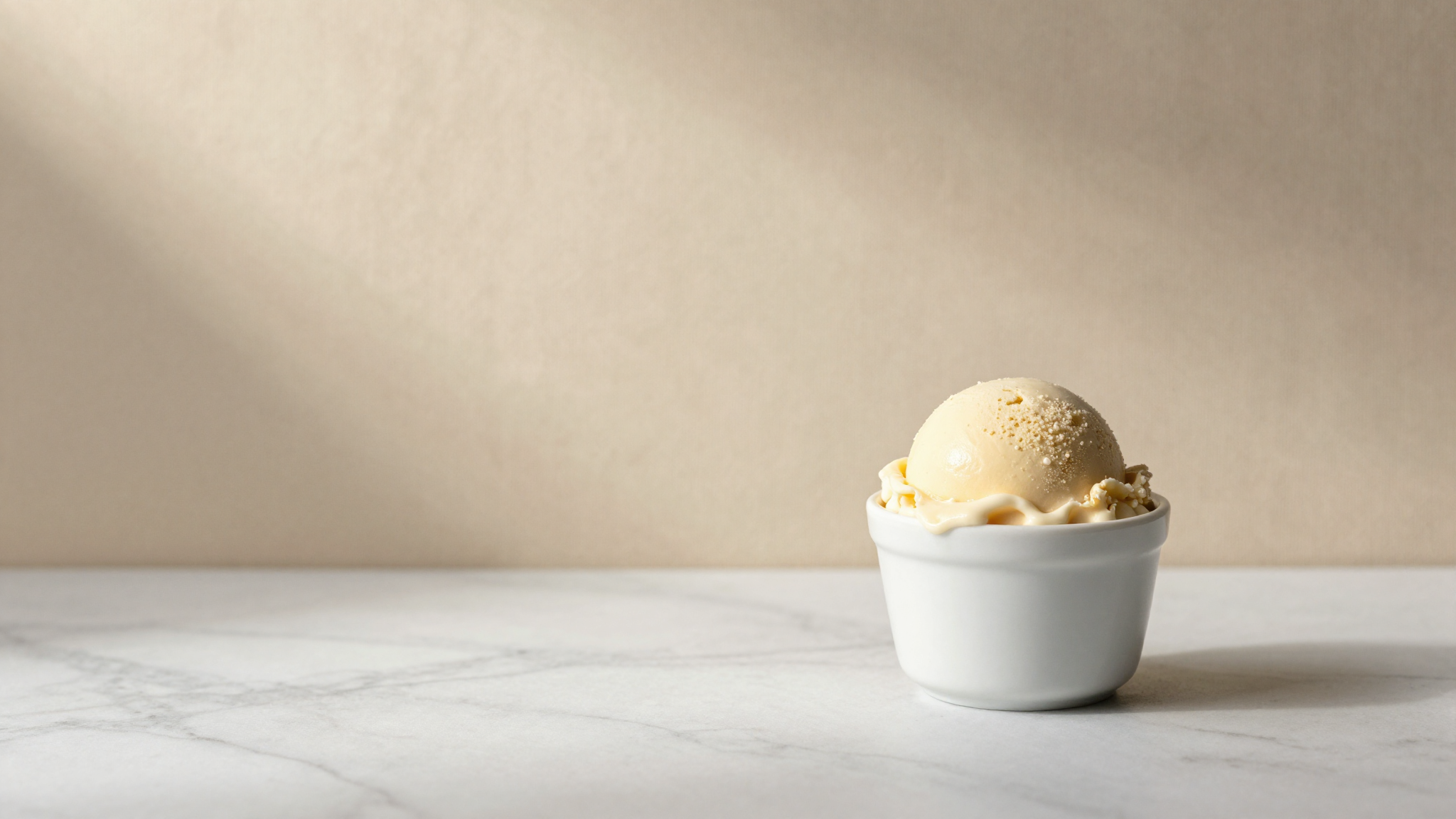 Italian gelato scoop in white ceramic cup on marble illustrating PAC anti-freezing power