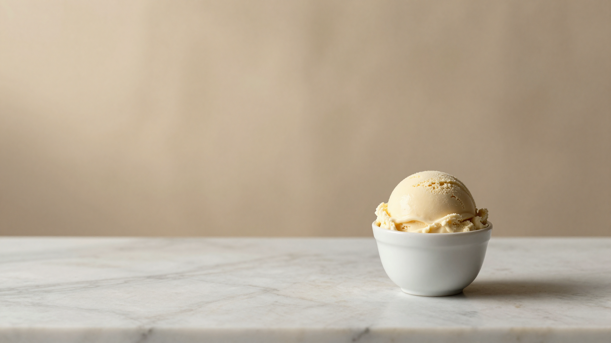 An Italian gelato lab counter with a small ceramic cup of gelato and a metal spoon under soft morning light, evoking texture diagnosis