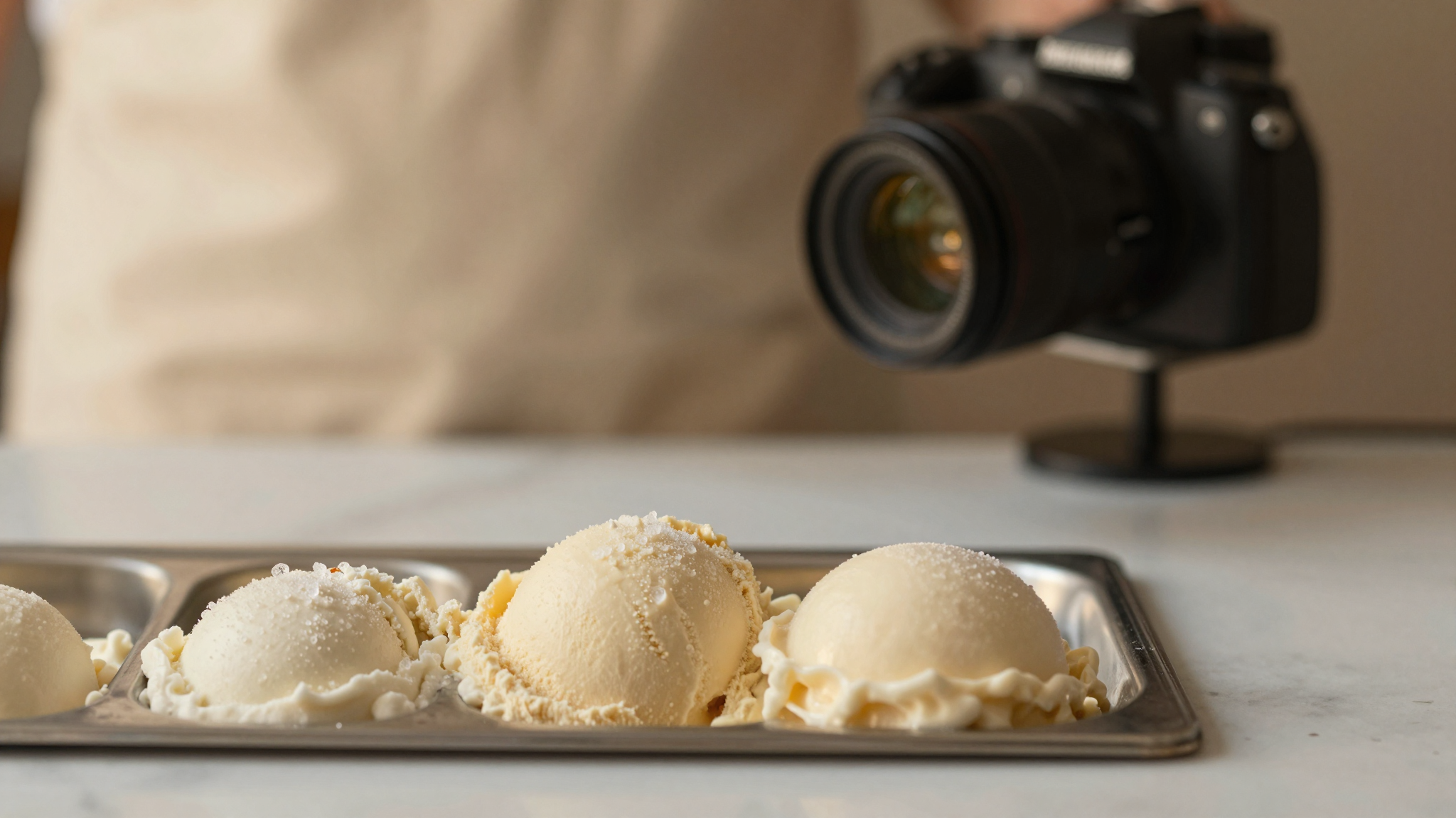 Close-up of artisanal gelato in a metal pan showing visible ice crystals and slightly grainy texture